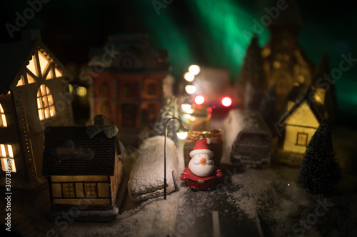 New Year miniature house in the snow at night with fir tree. Holiday concept. Selective focus © zef art
