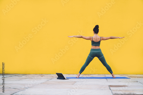 Unrecognizable woman standing in star pose