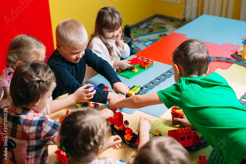 Educational toys for preschool and kindergarten child. Child playing with constructor blocks at class.