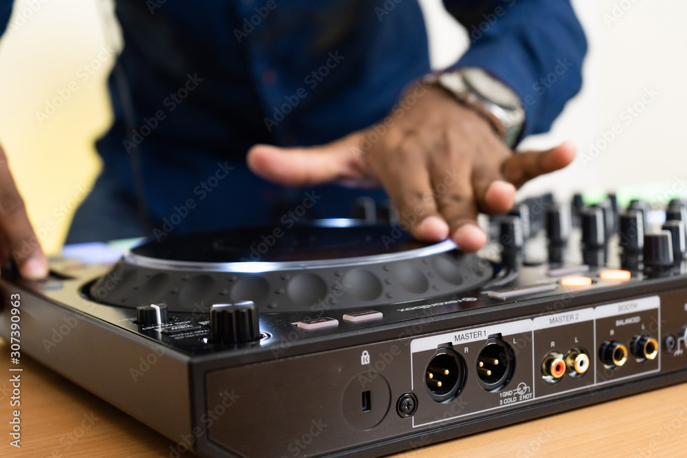 Dj mixes the track in the nightclub at party