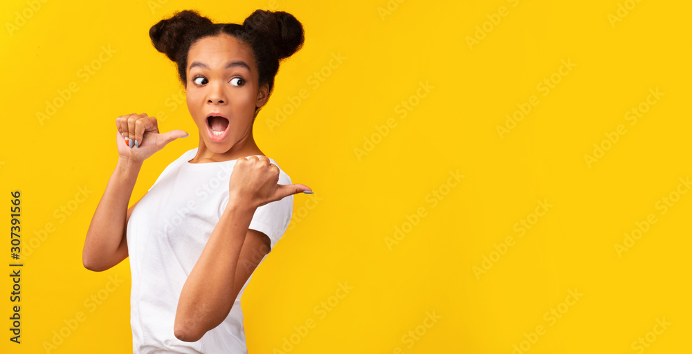 African girl pointing at free space with thumbs up African girl pointing at free space with thumbs up