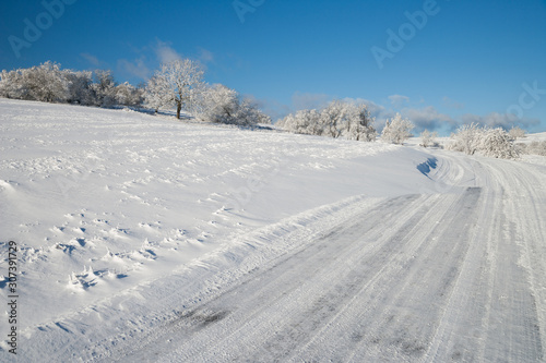 snow covered street at a beautiful sunny winter day © Alexander Erdbeer