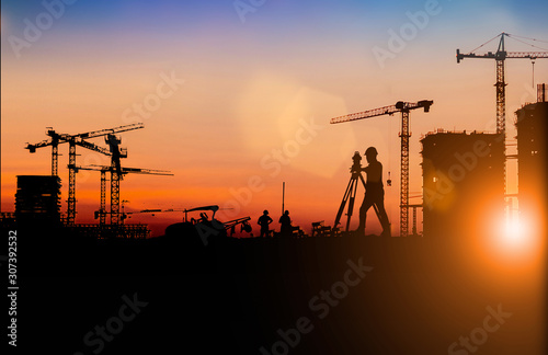 Silhouette of Survey Engineer and construction team working at site over blurred  industry background with Light fair Film Grain effect.Create from multiple reference images together