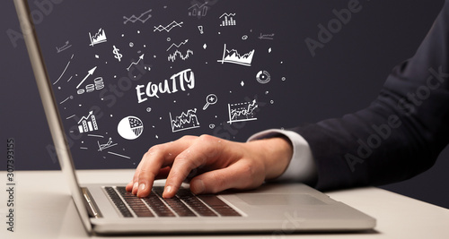 Businessman working on laptop with EQUITY inscription, modern business concept