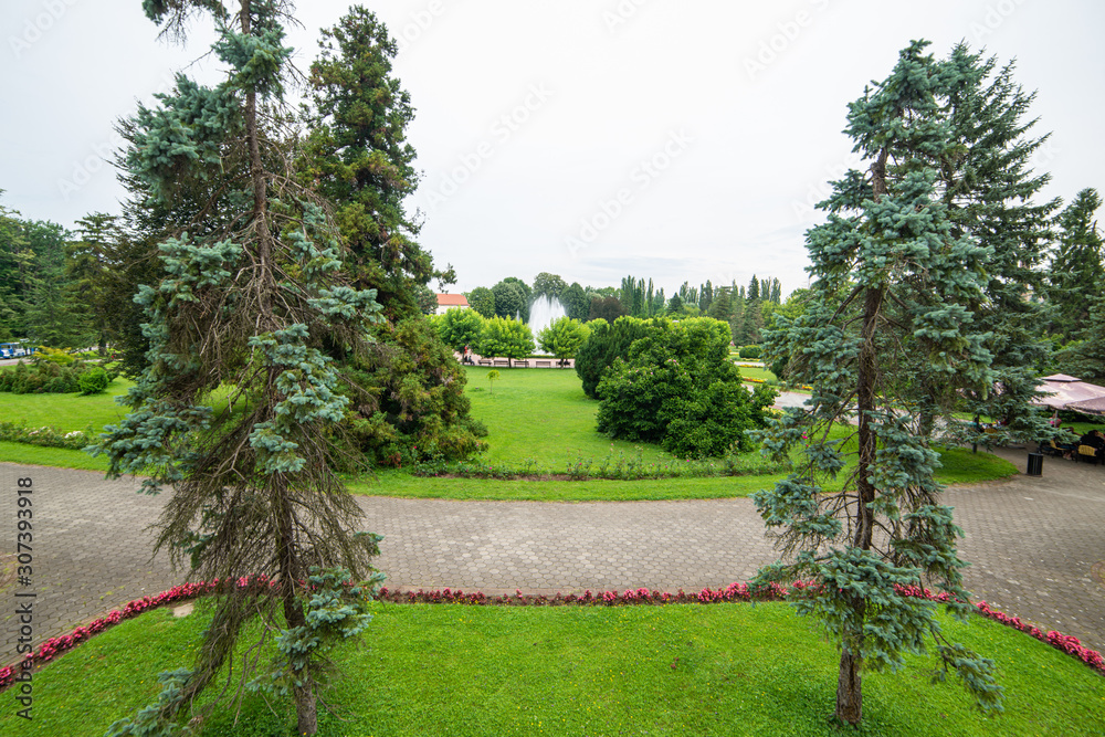 Banja Koviljaca, Serbia - July 13, 2019: Beautiful formal garden, park with trees, bush, flowers and architecture in medical wellness center Banja Koviljaca, leisure, disabilities and holiday