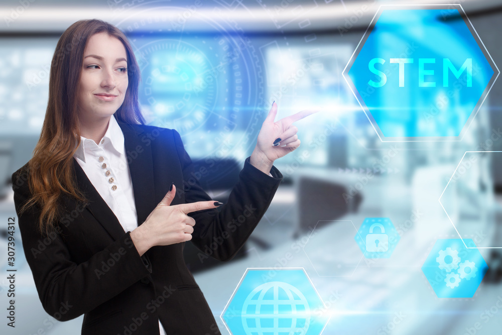 Business, Technology, Internet and network concept. Young businessman working on a virtual screen of the future and sees the inscription: STEM Business, Technology, Internet and network concept. Young businessman working on a virtual screen of the future and sees the inscription: STEM