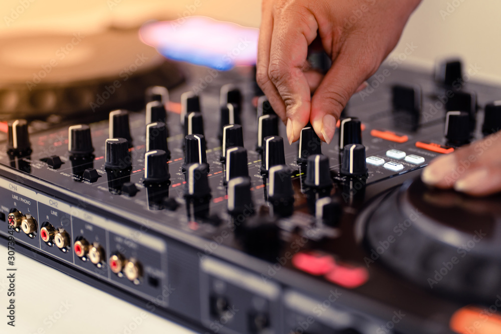 Hands of DJ mixing tracks on professional Dj Mixer Hands of DJ mixing tracks on professional Dj Mixer