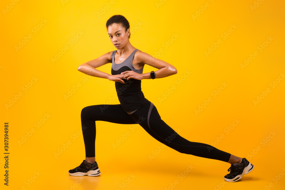 Black Girl Doing Deep Lunge Exercise Stretching Legs In Studio