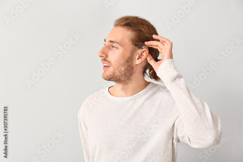 Young man with hearing aid ...