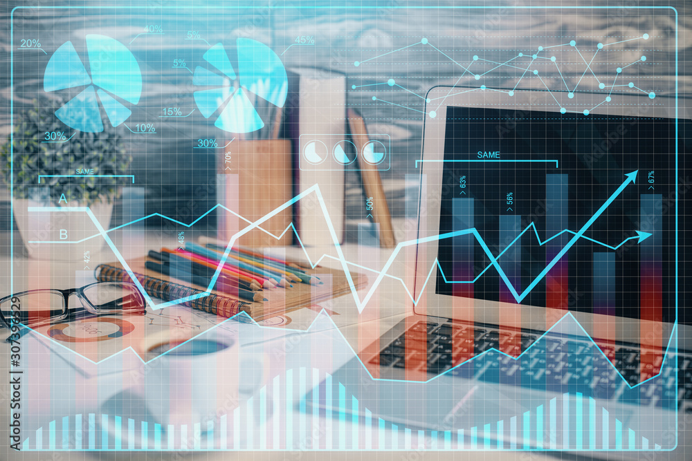 Financial graph colorful drawing and table with computer on background. Double exposure. Concept of international markets. Financial graph colorful drawing and table with computer on background. Double exposure. Concept of international markets.