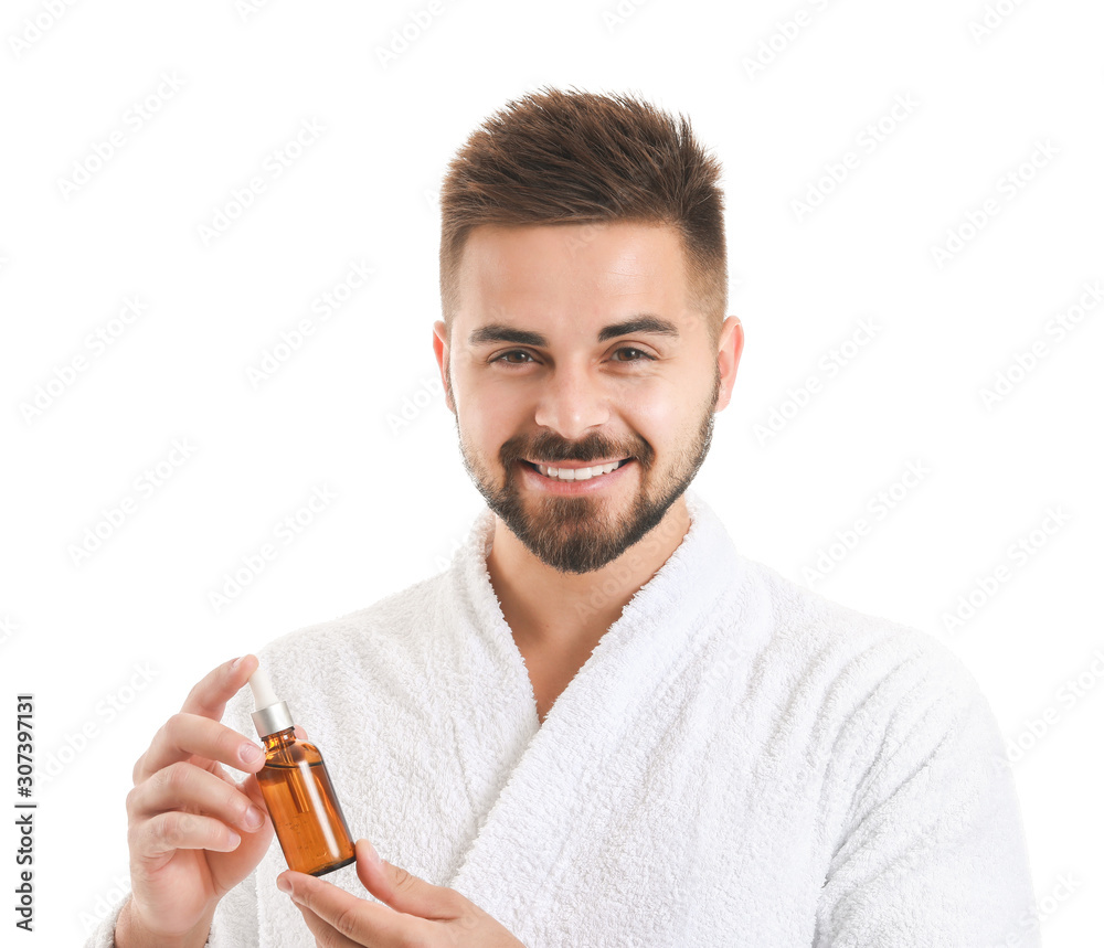 Handsome young man with cosmetic product on white background Handsome young man with cosmetic product on white background