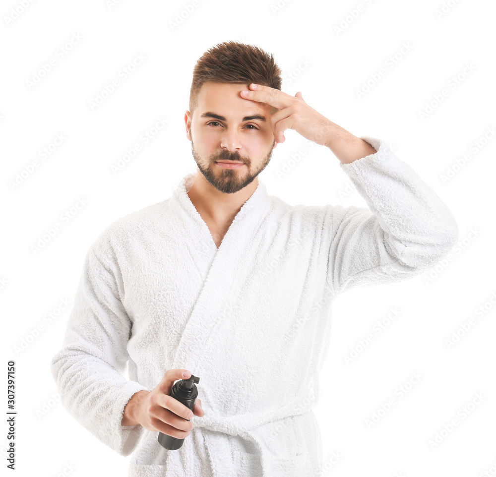 Handsome young man with cosmetic product on white background Handsome young man with cosmetic product on white background