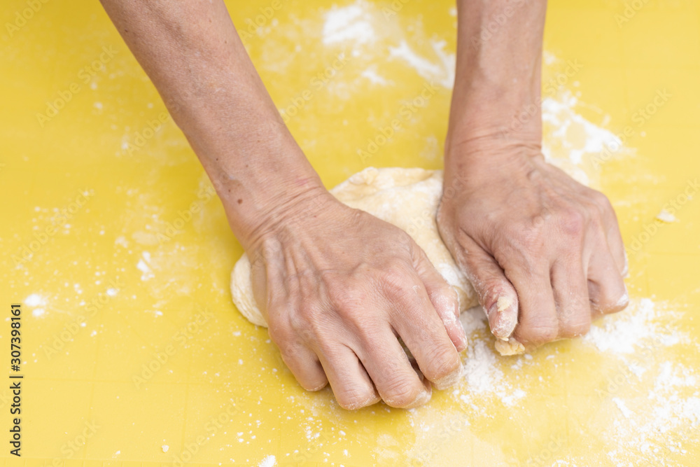 Female hands making dough for pizza Female hands making dough for pizza