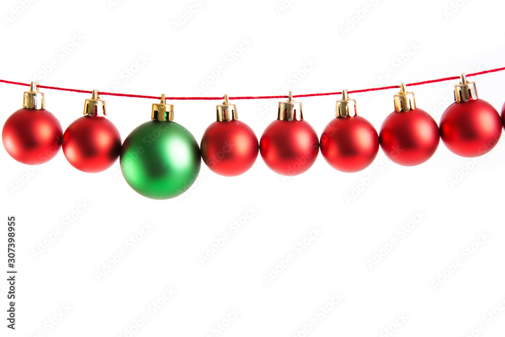 Line of red christmas balls and one green ball on white background. Christmas decorations. Line of red christmas balls and one green ball on white background. Christmas decorations.