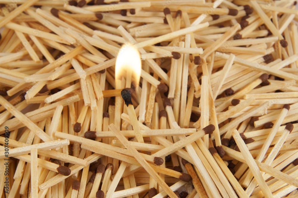 Burning matchstick on matchsticks background Burning matchstick on matchsticks background