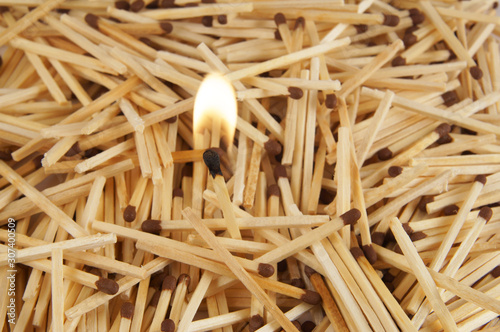 Burning matchstick on matchsticks background
