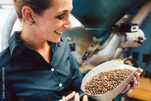 Woman in coffee roastery with fresh beans