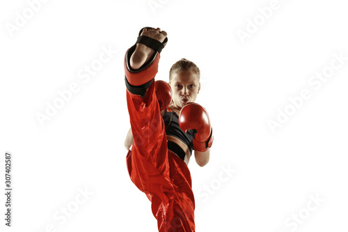 Fototapeta Young female kickboxing fighter training isolated on white background