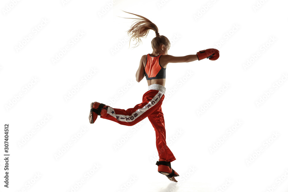 Young female kickboxing fighter training isolated on white background. Caucasian blonde girl in red sportswear practicing in martial arts. Concept of sport, healthy lifestyle, motion, action, youth. Young female kickboxing fighter training isolated on white background. Caucasian blonde girl in red sportswear practicing in martial arts. Concept of sport, healthy lifestyle, motion, action, youth.