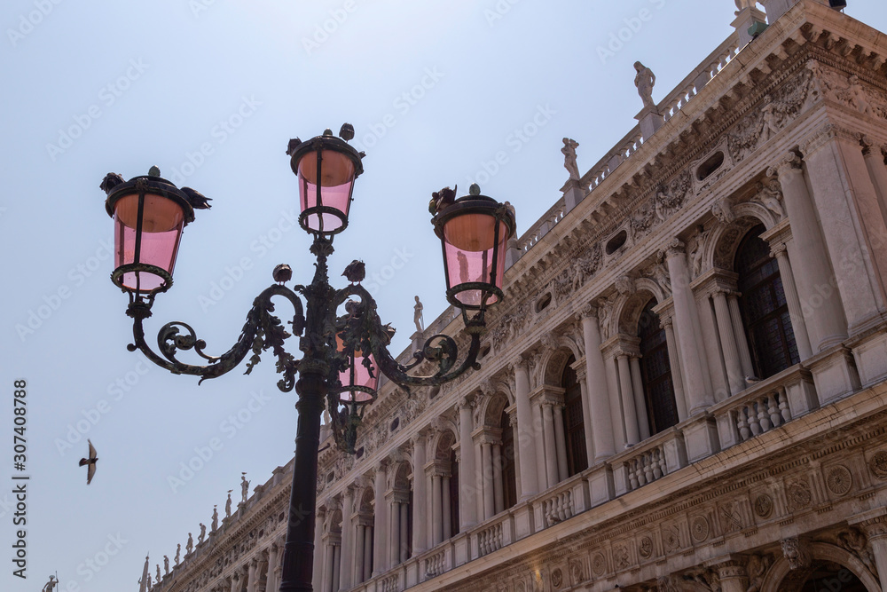 Detail of pink lanterns with birds in St Marks Square in front of  the national library in venice, Italy
