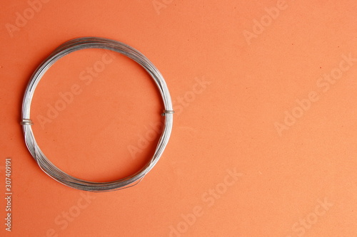 roll of metal wire of hardware store on colored background