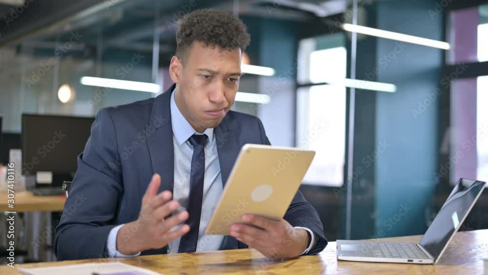 Disappointed Young Businessman reacting to Failure on Tablet Disappointed Young Businessman reacting to Failure on Tablet