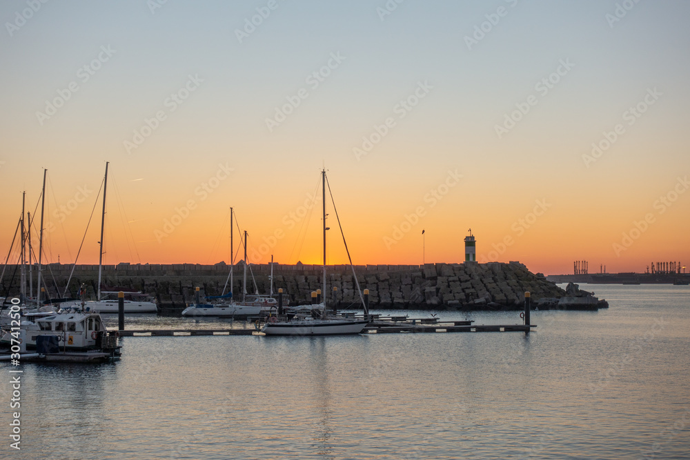 Sines marina with boats at sunset, in Portugal