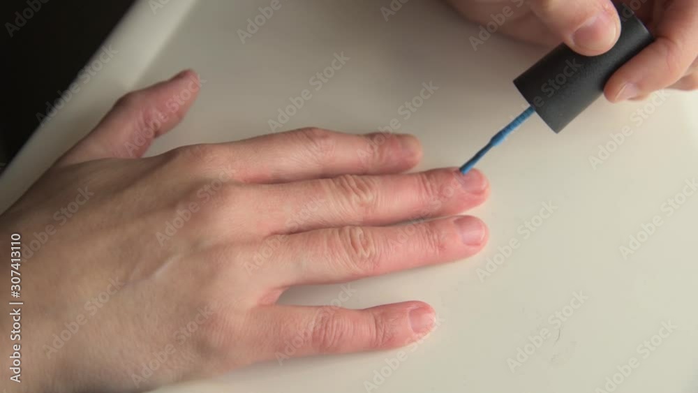 Woman Paints Fingernails Blue on Bathroom Sink Countertop 60fps Woman Paints Fingernails Blue on Bathroom Sink Countertop 60fps