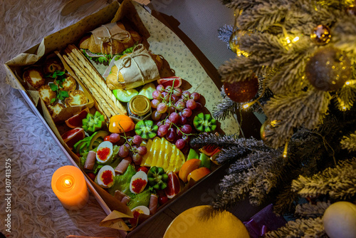 Delicious food near a Christmas tree by the candle © YuR-69
