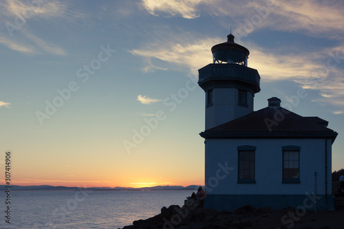 Lime Kiln Lighthouse at Lime Kiln Park on San Juan Island, Washington at sunset in June.