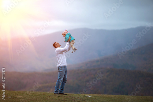 Father and daughter enjoy the snow in the mountains .