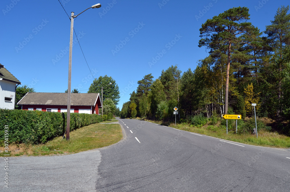 A typical Norwegian road in the countryside.  Ostfold Region, Norway