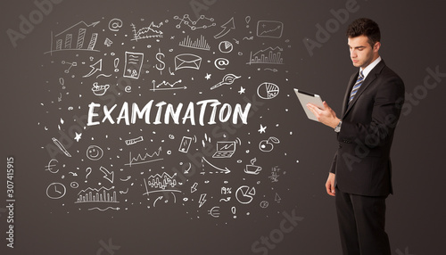 Businessman thinking with EXAMINATION inscription, business education concept