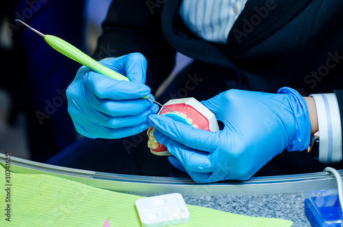 Close-up of denture manufacturing process. Tooth reconstruction.