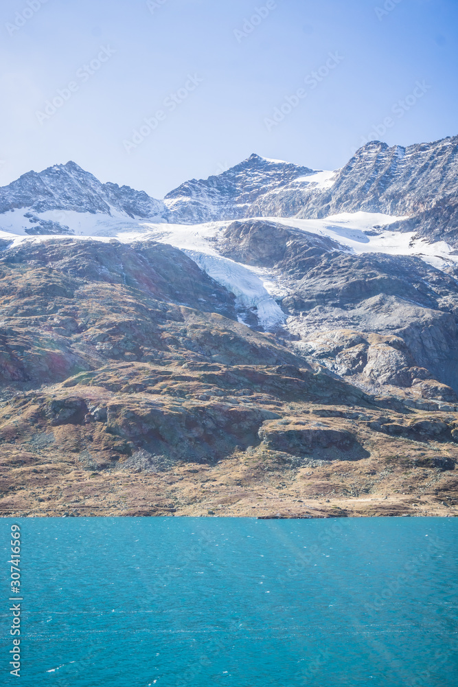 The Swiss mountains in the Engadine with woods, glaciers, near the village of Pontresina, Switzerland - October 2019. The Swiss mountains in the Engadine with woods, glaciers, near the village of Pontresina, Switzerland - October 2019.