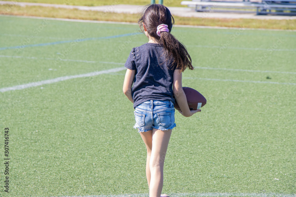 girl throwing a football
