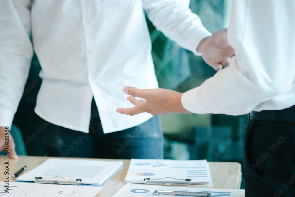 Business people analyzing investment graph meeting brainstorming and discussing plan in meeting room, investment concept Business people analyzing investment graph meeting brainstorming and discussing plan in meeting room, investment concept