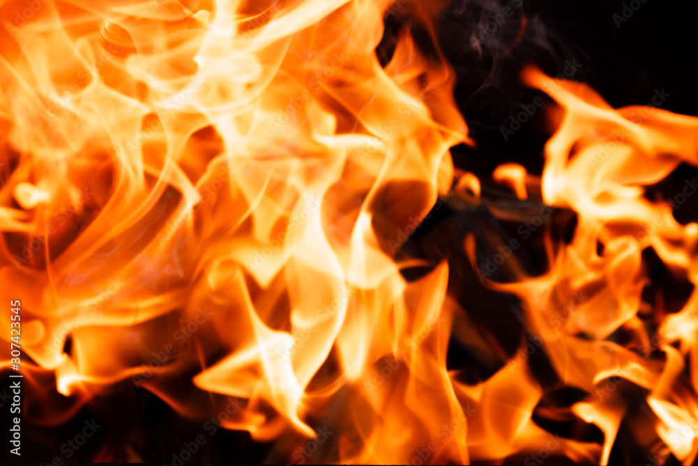 Texture of a flame of fire on a black background. burning fire in a stove closeup Texture of a flame of fire on a black background. burning fire in a stove closeup