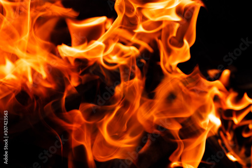 Texture of a flame of fire on a black background. burning fire in a stove closeup