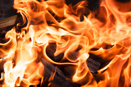Texture of a flame of fire on a black background. burning fire in a stove closeup