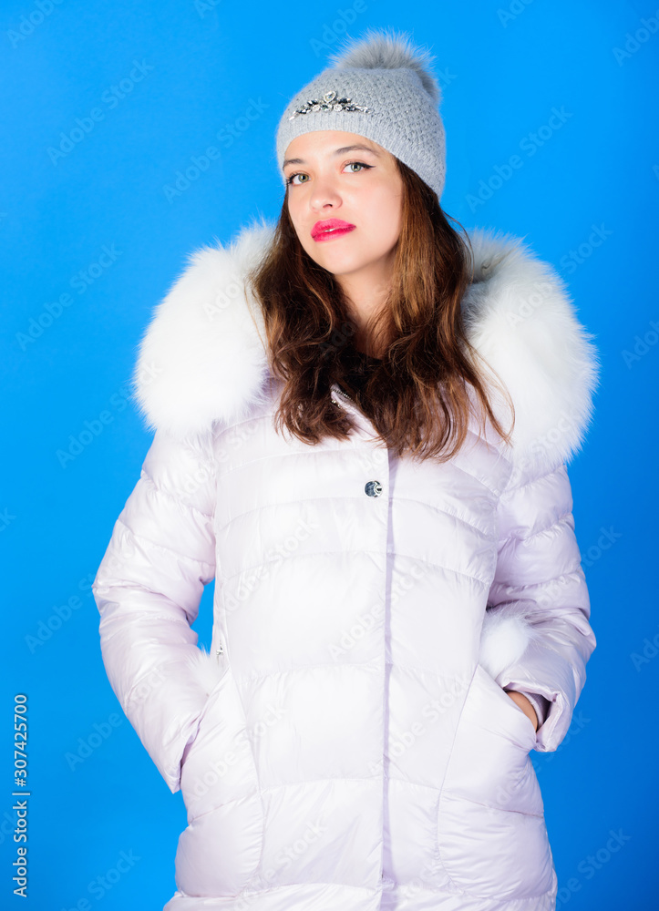 Woman wear down jacket. Style code with elegance. For those wishing stay  modern. Winter clothes. Warm and cozy. Girl wear winter jacket blue  background. Fashion trend. Winter season of contrasts Photos