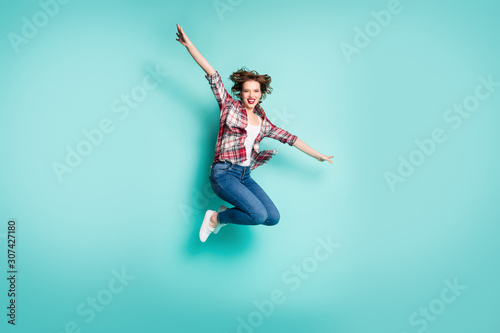 Full length photo of cheerful excited girl jump hold hands imagine idea she bird plane fly in sky wear stylish clothes isolated over teal color background