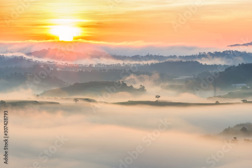Foggy mountain range landscape at beautiful sunrise morning © Quang