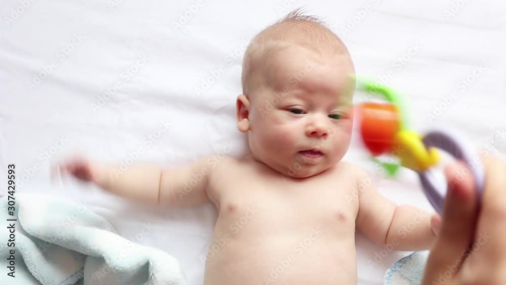 baby responds to ringing toy, checking baby's hearing and attention baby responds to ringing toy, checking baby's hearing and attention