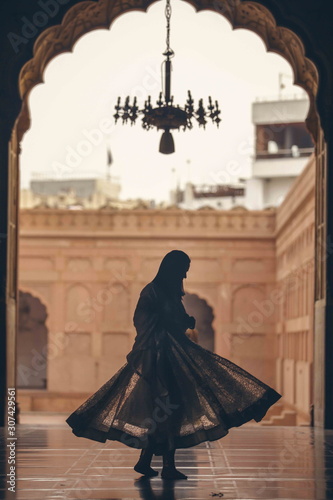 silhouette of bride and groom in front of tomb