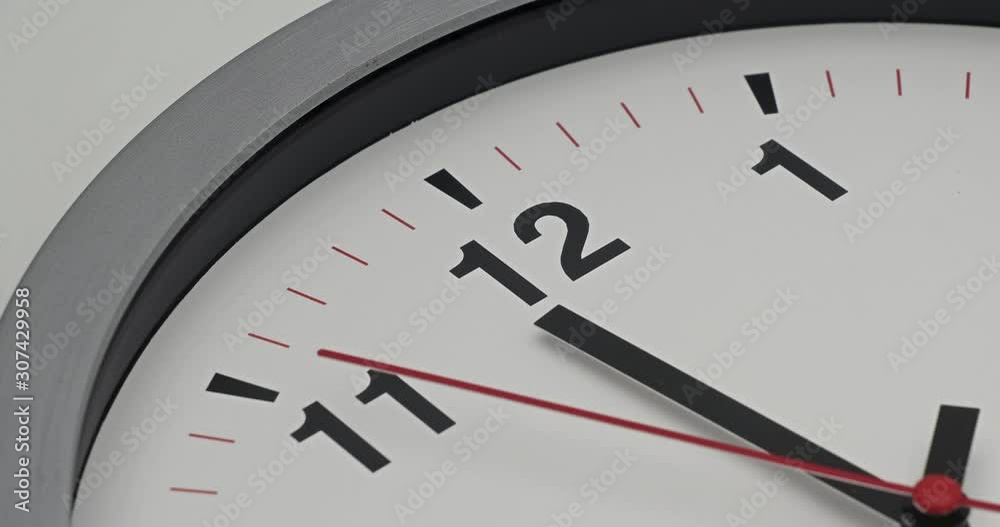 Truck shot of time-lapse gray clock with black arrows shows motion the time speed up from 11.00 p.m. and slow down to 12.00 p.m., How time flies concept. Truck shot of time-lapse gray clock with black arrows shows motion the time speed up from 11.00 p.m. and slow down to 12.00 p.m., How time flies concept.