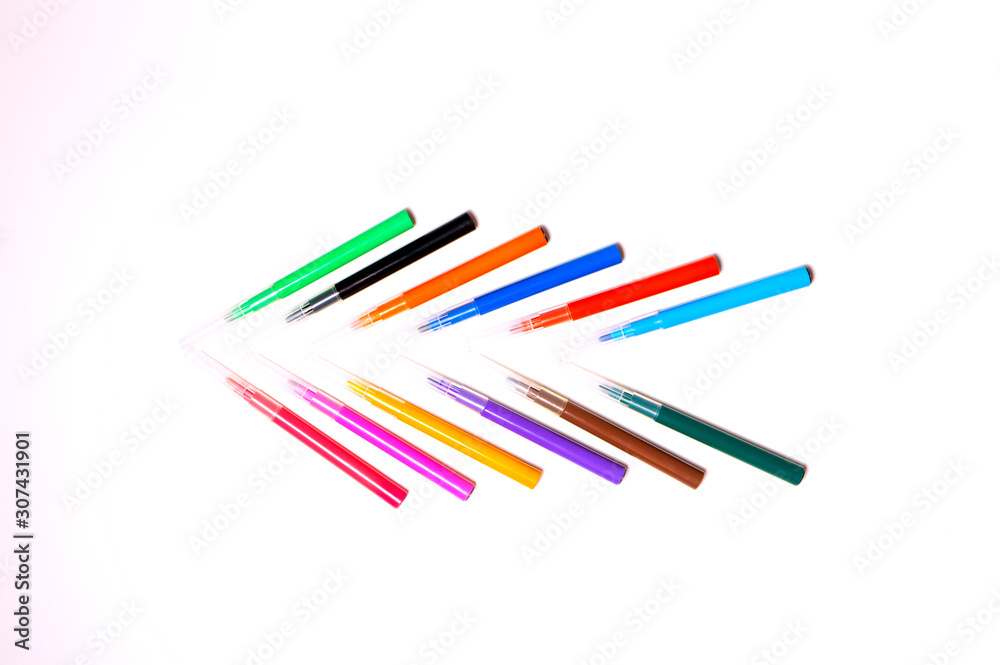 Colorful felt-tip pens on the white background. Markers and pencils pattern. Background or texture. Colorful felt-tip pens on the white background. Markers and pencils pattern. Background or texture.