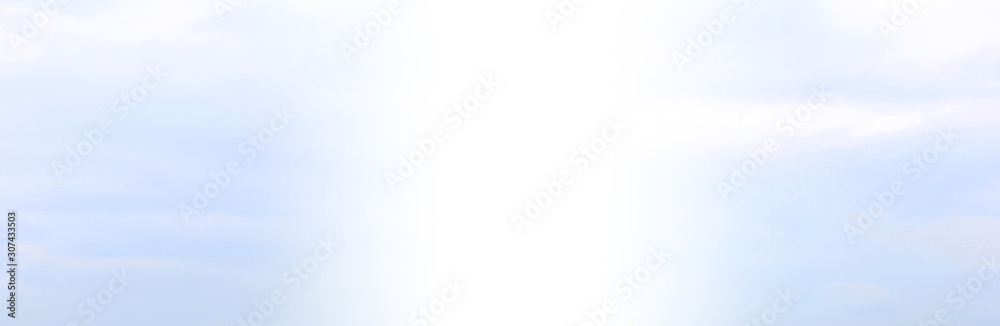 Light blue and white sky background. Bright sky texture with small clouds, wide horizontal mockup with blank white copy space Light blue and white sky background. Bright sky texture with small clouds, wide horizontal mockup with blank white copy space