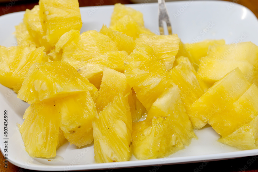 Close up slice pineapple background texture in white dish. Slide and piece of fresh fruit. Close up slice pineapple background texture in white dish. Slide and piece of fresh fruit.