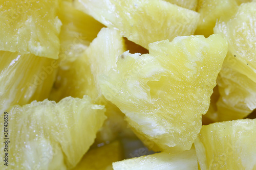 Close up slice pineapple background texture in white dish. Slide and piece of fresh fruit.